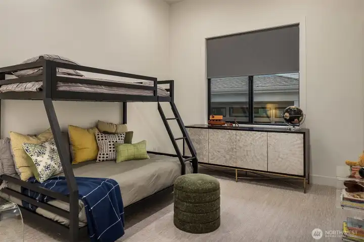 A versatile secondary bedroom with vaulted ceilings and room for everyone — the second wing of the floor plan doing exactly what it was designed to do.