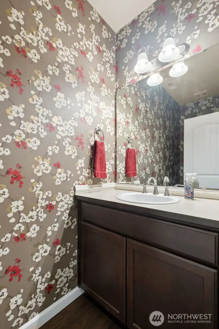Half bath on the main level with custom wall paper. Half bath on the main level with custom wall paper.