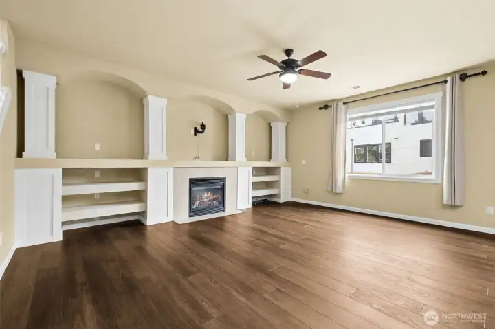 Lots of storage and display on each side of the gas fireplace w/tile surround and wood wrapped columns. Lots of storage and display on each side of the gas fireplace w/tile surround and wood wrapped columns.