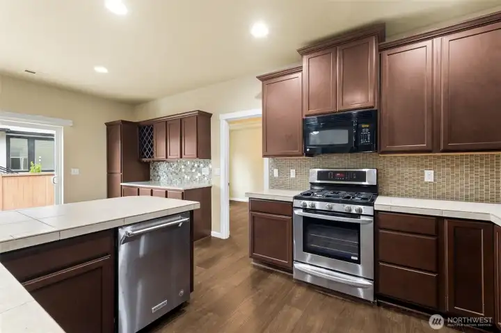 LG and KitchenAid stainless steel appliances, 5 burner gas range w/built in microwave. Tiled counters are in perfect shape or update with your own choice later. LG and KitchenAid stainless steel appliances, 5 burner gas range w/built in microwave. Tiled counters are in perfect shape or update with your own choice later.