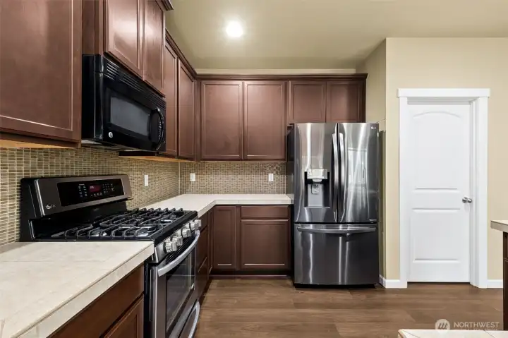 LG stainless French style fridge w/water and ice in door. Large panty door to the right. LG stainless French style fridge w/water and ice in door. Large panty door to the right.