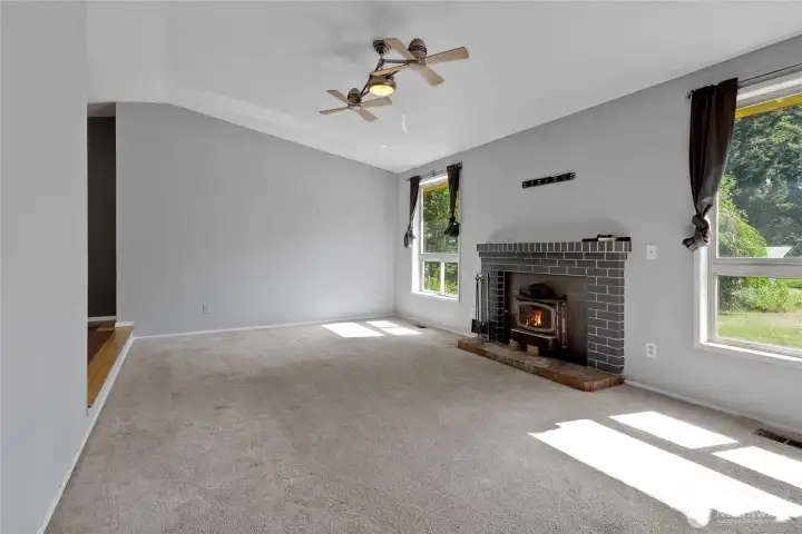 Spacious family room with front-facing windows that bring in natural light and provide a comfortable gathering area.