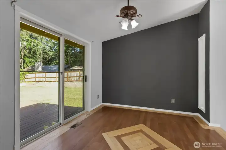 Additional view of the dining area featuring a slider that opens directly to the brand-new deck, creating seamless indoor-outdoor flow for everyday living and entertaining.