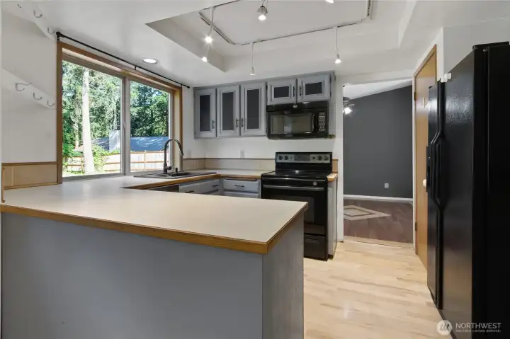Additional views of the kitchen showcasing functional layout, eating space, and seamless flow to the dining area—designed for everyday living and easy entertaining.