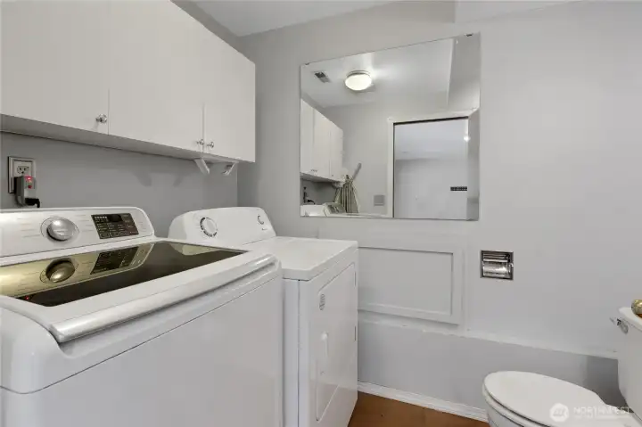 Convenient downstairs laundry room with washer and dryer included, plus an additional toilet for added functionality and everyday convenience.