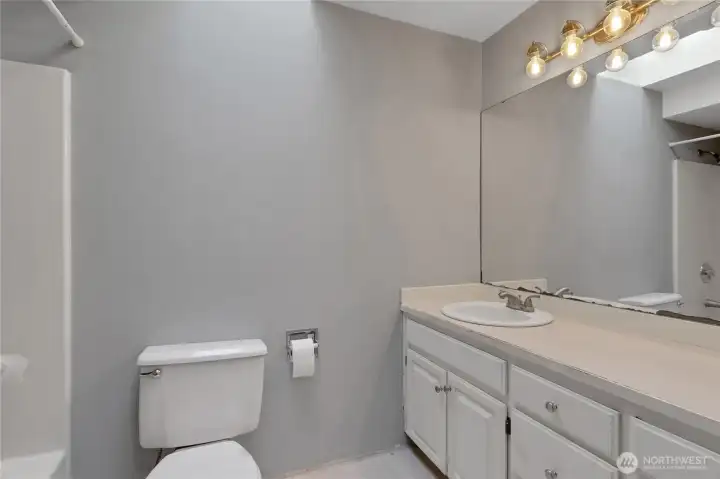 Well-appointed full bath with tub/shower combo, toilet, and vanity, designed for convenience and daily functionality.