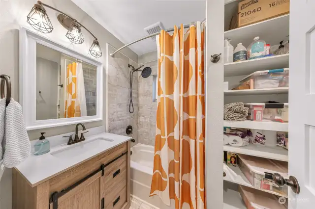 Generously sized bathroom with ample storage space.