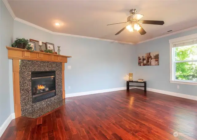 Kitchen open to great room living space with gas fireplace.