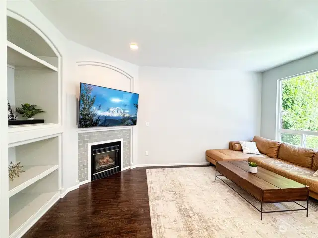 Open floor plan from family room to kitchen with eating area allows for view of playground area and backyard. Lots of natural light!