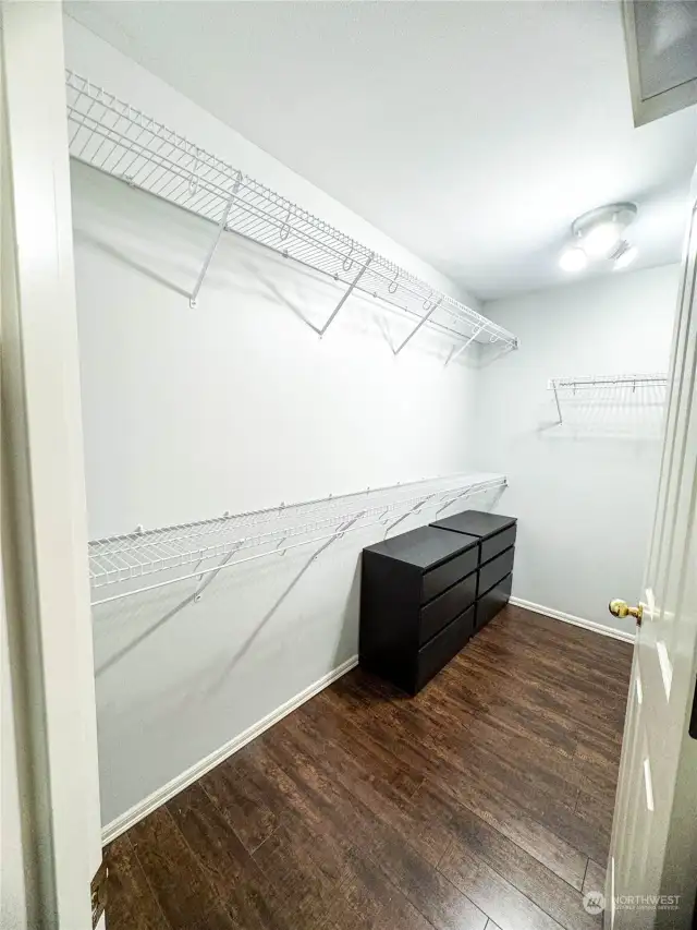Primary bedroom walk-in closet. It even turns the corner to the right for more room. So spacious!