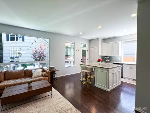 Open floor plan from family room to kitchen with eating area allows for view of playground area and backyard. Lots of natural light!