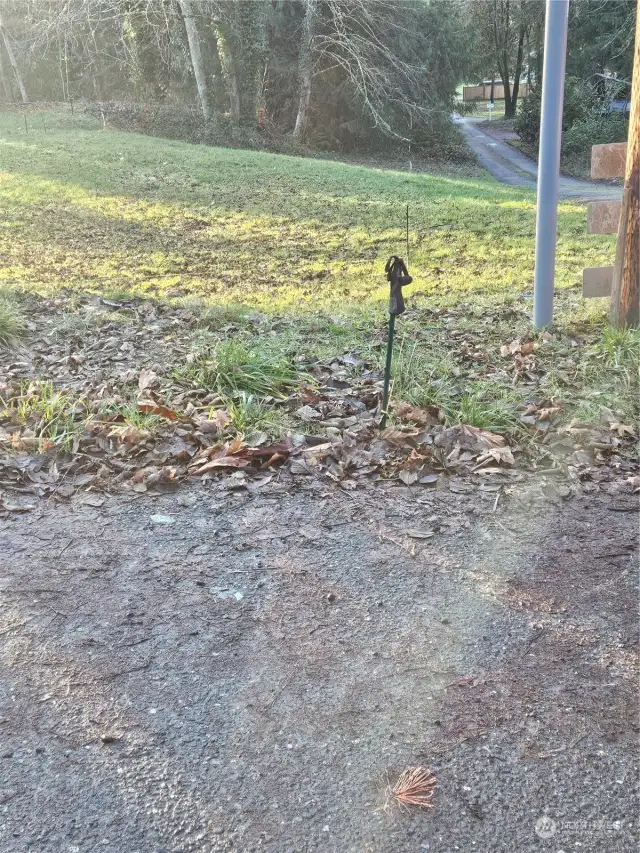 Corner marker is in the driveway at intersection to Sipes Lane.  Lot is laid out and staked for a 3 bedroom rambler 1721 sq.ft. plan by HiLine Homes.