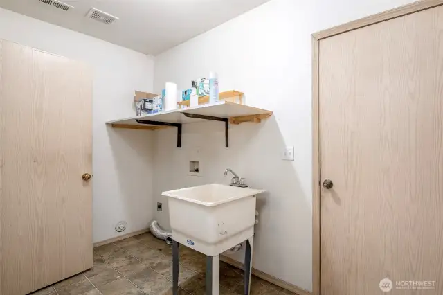 Lower level laundry room with attached half bath