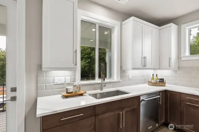 Undercabinet lights and the full height tile backsplash highlight the beauty of this kitchen.