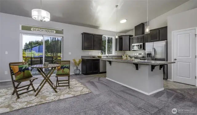 Dining area next to the open kitchen and also next to the slider to back deck.