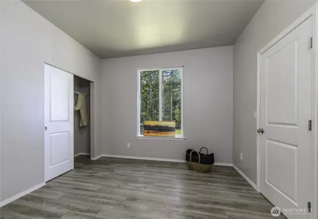 This bedroom has easy to clean floors, no carpet. Could be used for a gym.