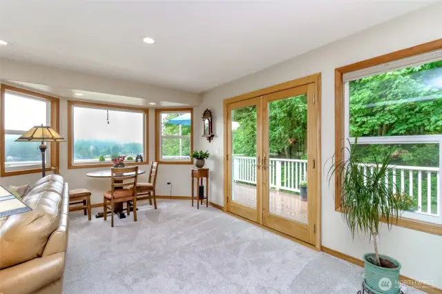 French doors make for a seamless connection to outdoor living spaces including the full wrap around deck.