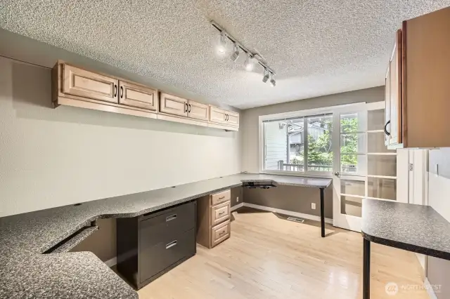 In front of the home off the entry is a large study with two built-in desks and abundant cabinetry. Hardwood floor.