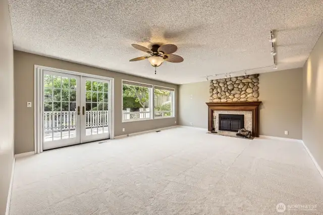 Enjoy relaxing in this large family room with one of three wood-burning fireplaces with a custom mahogany mantle and faux river rock accents