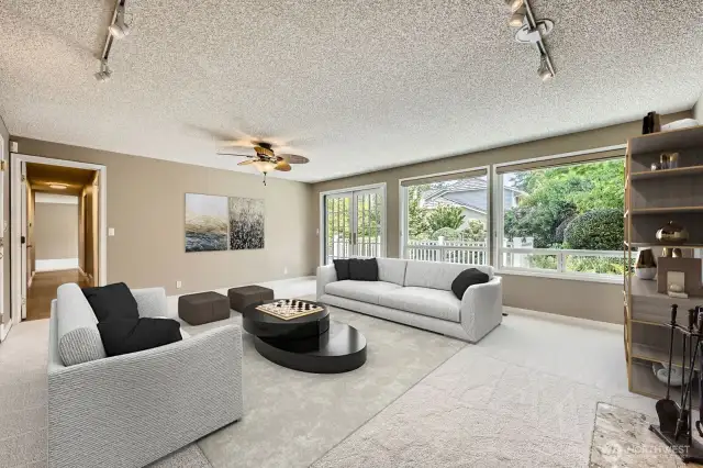 A huge family room where you can lounge and relax. The main focus is a large wall of windows and new Marvin French doors. Plus, the beautiful landscaping and pool are seen directly from the room, offering a gorgeous view.