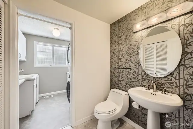 The elegant powder room on the main floor boasts a pedestal sink and marble terrazzo tile flooring.