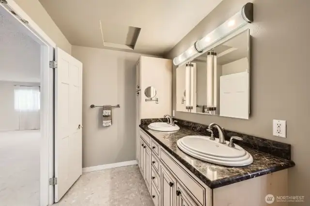The spacious primary bath features dual sinks, marble terrazzo tile floors and a double door entry.