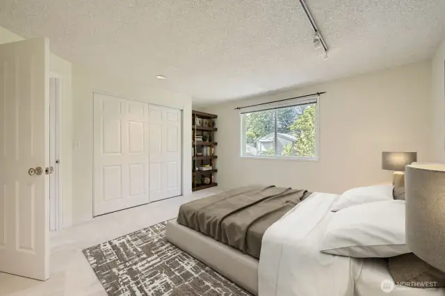 The light-filled fourth bedroom is spacious with newly installed carpeting.