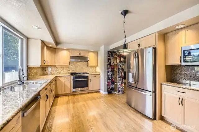 The pull-out pantry with it's poster wall paper is a fun addition to this spacious kitchen.  Abundant counterspace, cabinetry and new stainless steel appliances.