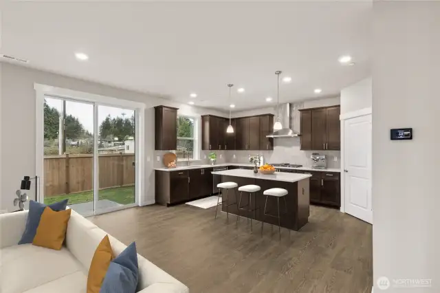 Well-appointed kitchen with gas cooktop, huge pantry adjacent to mud room just off the garage. 48" counter depth side-by-side refrigerator. Plenty of space to entertain!  Very open layout, view will vary as this was from the same plan within the community - Home to include white cabinetry.