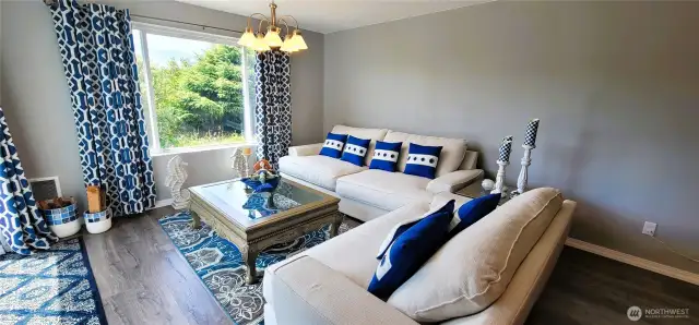 Sun-drenched and elegantly appointed, this canal-side living room offers seamless indoor-outdoor living with sliding glass doors opening directly to the backyard, firepit, and kayak launch. Sophisticated furnishings and rich floors create a cozy yet refined setting—where every detail echoes Surfside serenity