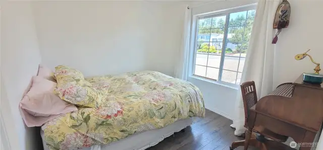 Bright and multifunctional, this guestroom doubles as a cozy home office—perfect for hosting visitors or working in peace. With warm floors and a sunny window, it’s a stylish, low-maintenance space that blends comfort and productivity with a touch of coastal charm.