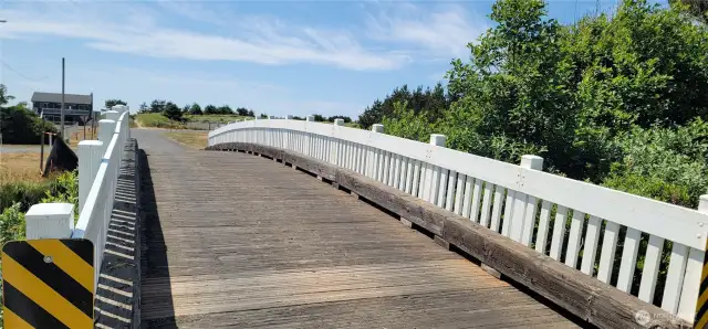 Just steps away, the Surfside community bridge offers quick access to scenic ocean trails winding through coastal dunes. Whether you're heading out for a morning stroll or a sunset walk to the beach, this charming path connects you effortlessly to the natural beauty that defines Surfside living