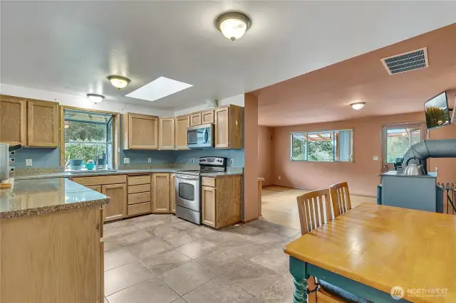 The kitchen boasts quartz countertops and a tile floor.