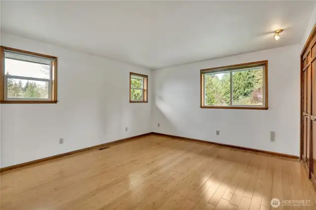 Main level primary bedroom with lots of windows.