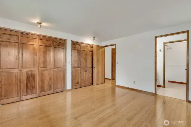 The primary bedroom has a wall of closets and a private bath.