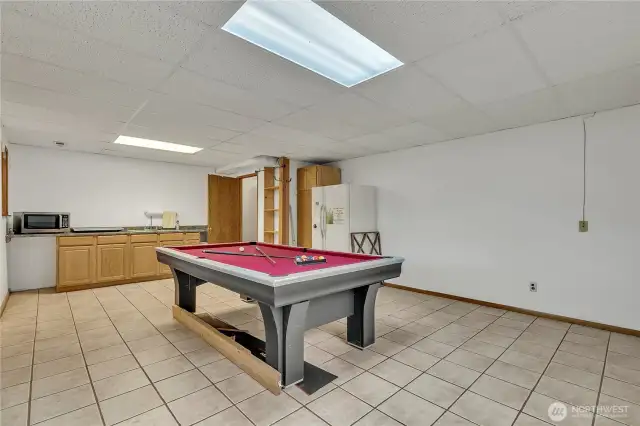 The lower level family room comes equipped with a kitchen vanity and sink.