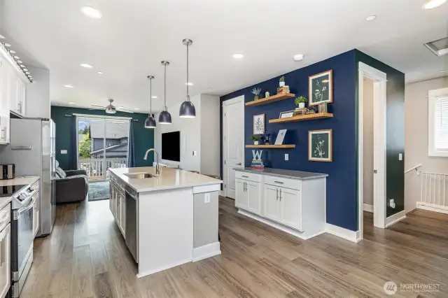 Kitchen also features versatile space with floating shelves—ideal for a coffee bar, stylish display, or home organization hub.
