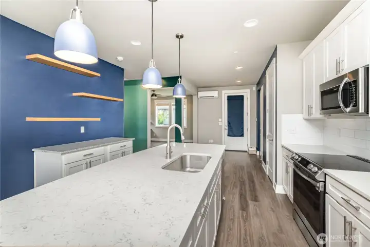 Another view of this open kitchen highlights its spacious layout, modern finishes, and seamless flow into the living areas.
