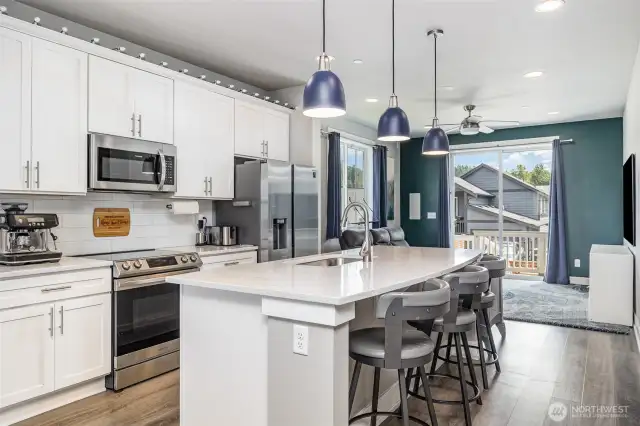 Another view of this open kitchen highlights its spacious layout, modern finishes, and seamless flow into the living areas.