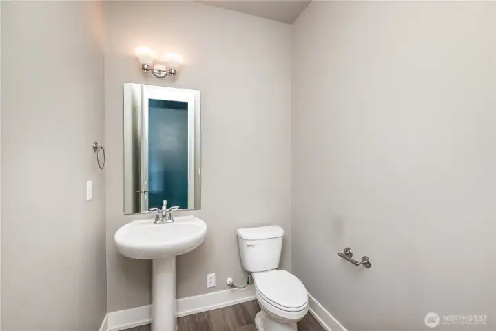 Main floor powder room includes a convenient outlet behind the toilet—perfectly suited for bidets or smart toilet seats.