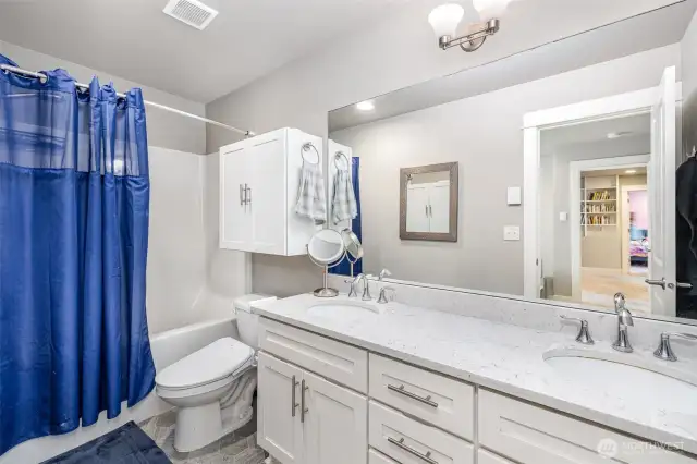 Primary en-suite features dual sinks with quartz countertops, ample storage, and a dedicated outlet for bidets or smart toilet seats—combining comfort with modern convenience.