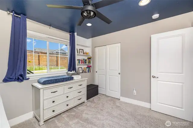 Another view of the guest bedroom highlights the ceiling fan and convenient wall switch—every room is pre-wired and equipped for added comfort.