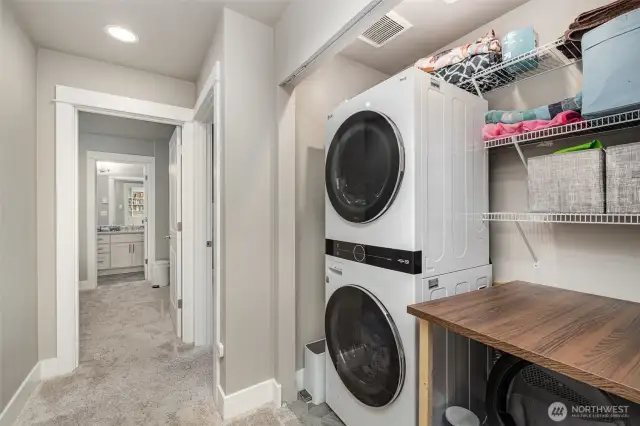 Downstairs hallway offers convenient washer and dryer access near the bedrooms. The home also features Mysa Smart WiFi thermostats controlling each in-wall heater and the AC/mini-split for personalized comfort.