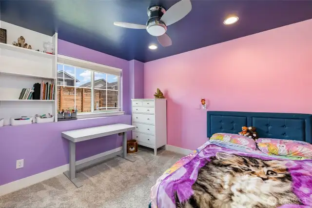 Second downstairs guest bedroom featuring ceiling fan, recessed lighting, and built-in shelving.
