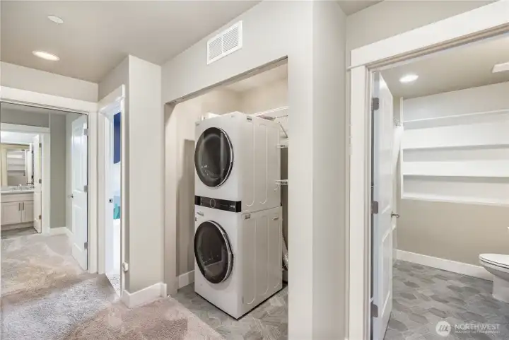 Downstairs hallway offers convenient washer and dryer access near the bedrooms. The home also features Mysa Smart WiFi thermostats controlling each in-wall heater and the AC/mini-split for personalized comfort.