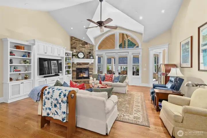 Great room has 12' vaulted ceilings, custom built home entertainment center, and stone fireplace with gas insert.
