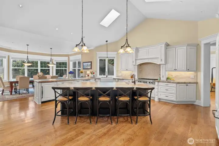 Incredible kitchen has 8' center island with prep sink, seats five, and has built-in microwave, warming drawer, and cabinet for stand-up mixer.
