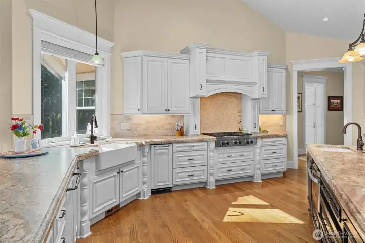 Undermount farm sink with window overlooking the rose garden.  Built-in trash compacter.  Wolf 6-burner gas cook top!