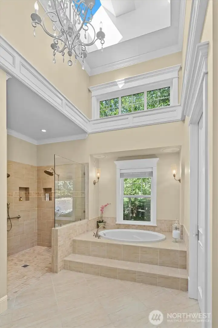 Amazing primary bathroom with high ceilings, chandelier, and skylights.  Heated floors!