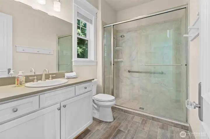 This pool house bathroom doubles as a changing room before and after swimming.